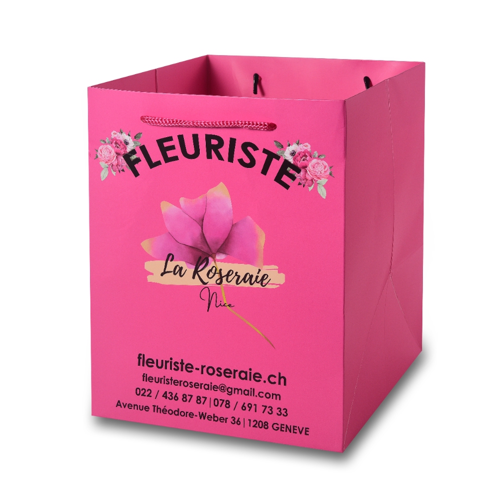 Custom Flower Shop Paper Bag - wejoypackaging.com Bright pink custom flower shop paper bag with printed logo, floral graphic and braided rope handles for retail packaging.